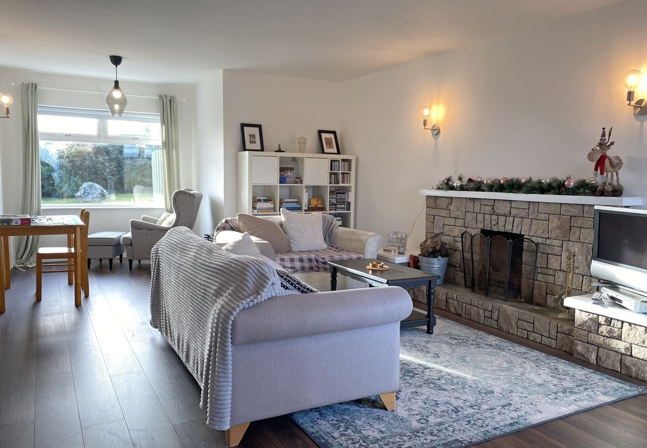 Glynsk Holiday Home. Cosy living room Traditional furniture, open fire, views.