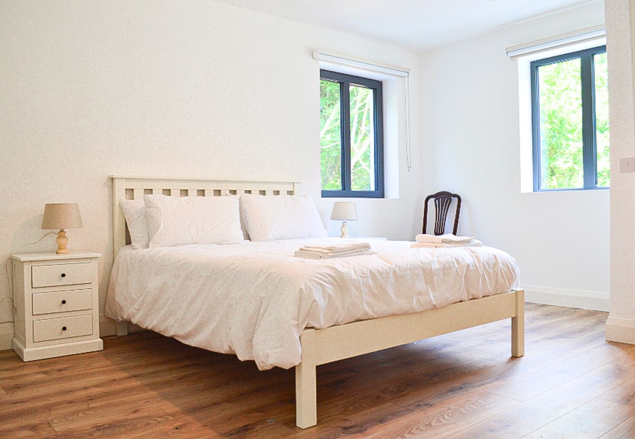 Lough Conn Haven Holiday Home. Bright modern double room. Large windows, view to garden. Wooden floors.