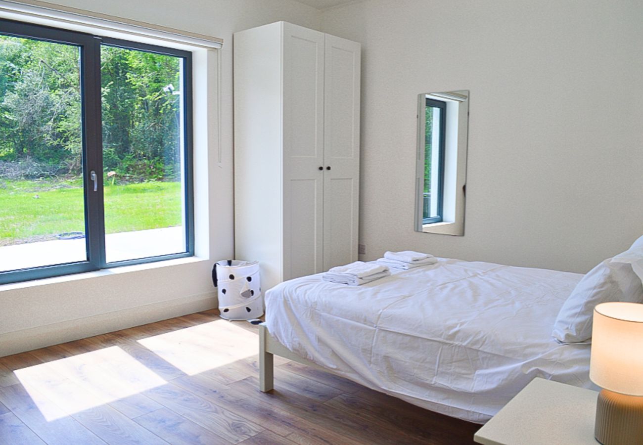 Lough Conn Haven Holiday Home. Bright modern stylish bedroom with views to the garden. 