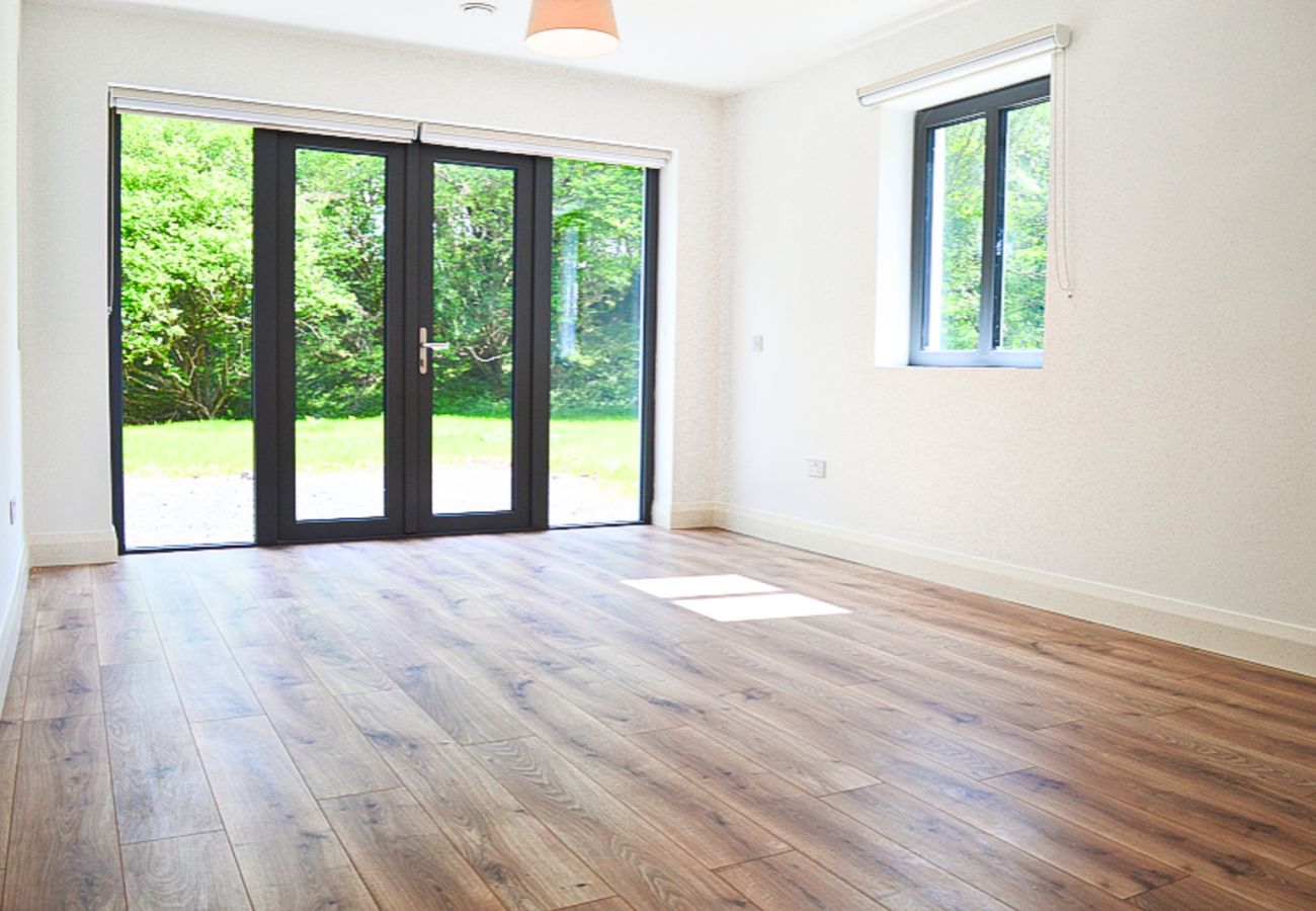 Lough Conn Haven Holiday Home. Bright modern spare room wooden floors. 
