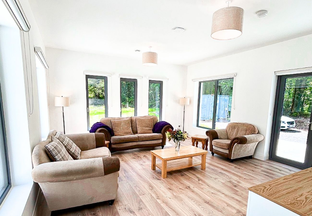 Lough Conn Haven Holiday Home. Open plan spacious bright lounge. Wooden floors, large windows, modern comfortable furniture. 