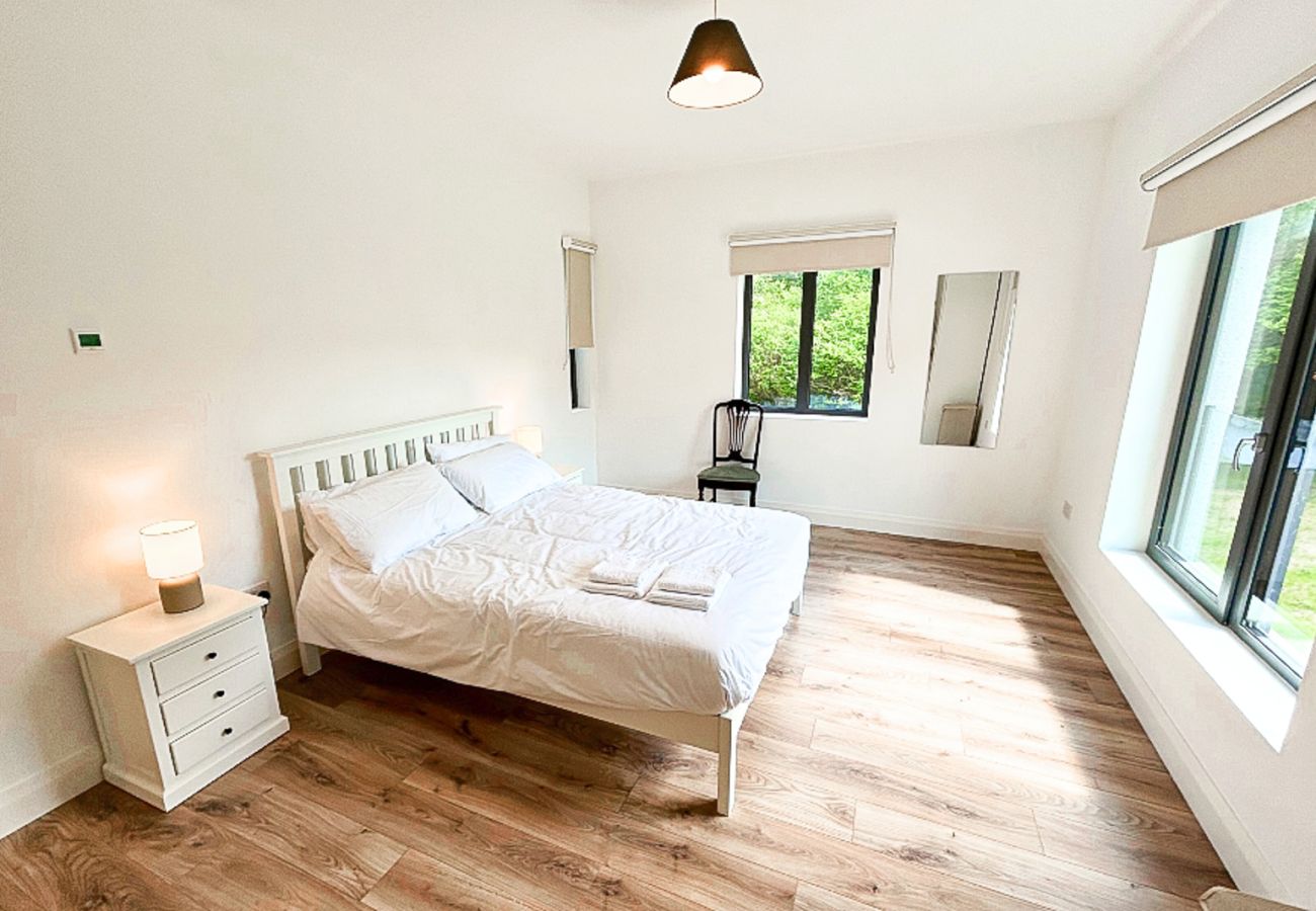 Lough Conn Haven Holiday Home. Bright modern double room, large windows view to garden. Wooden floor. 