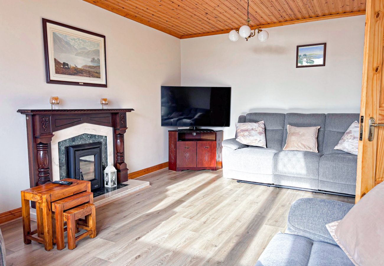 Kilkieran Holiday Home Connemara, comfortable living room, solid fuel stove, TV, good views. 