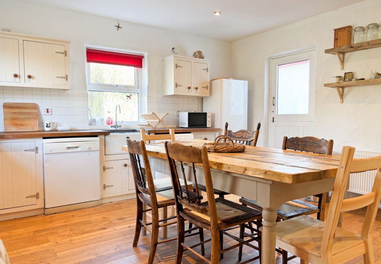 Moyard Stone Cottage, Connemara.  Country cottage style kitchen. Dining table for 6. Cozy style. 