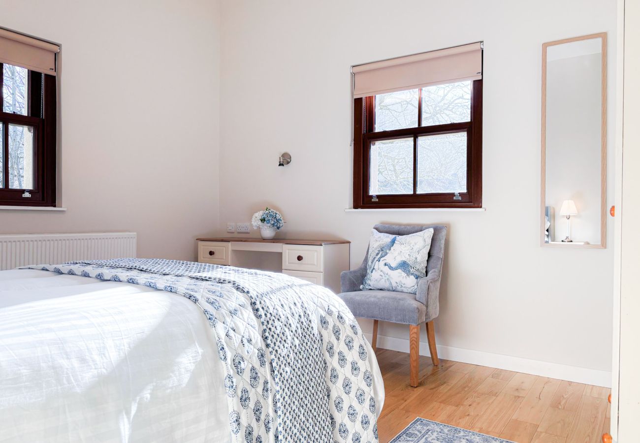 Kylemore Woodland Holiday Cottage, Double bedroom, window and chair. 