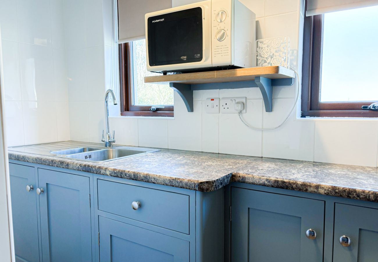 Kylemore Woodland Holiday Cottage. Compact modern kitchen with microwave