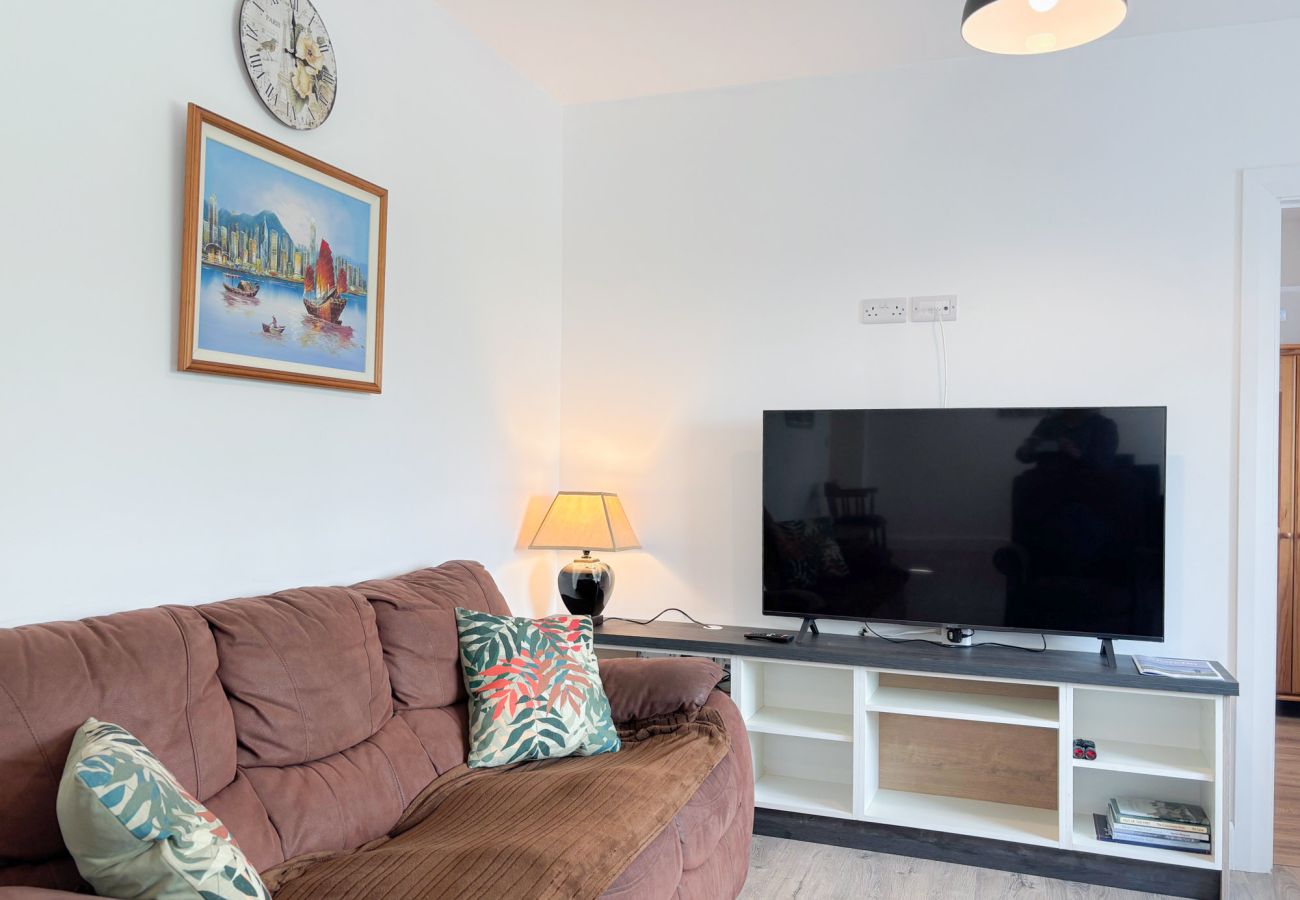 Bluebell Cottage Roundstone.  Living room suite open plan with large TV