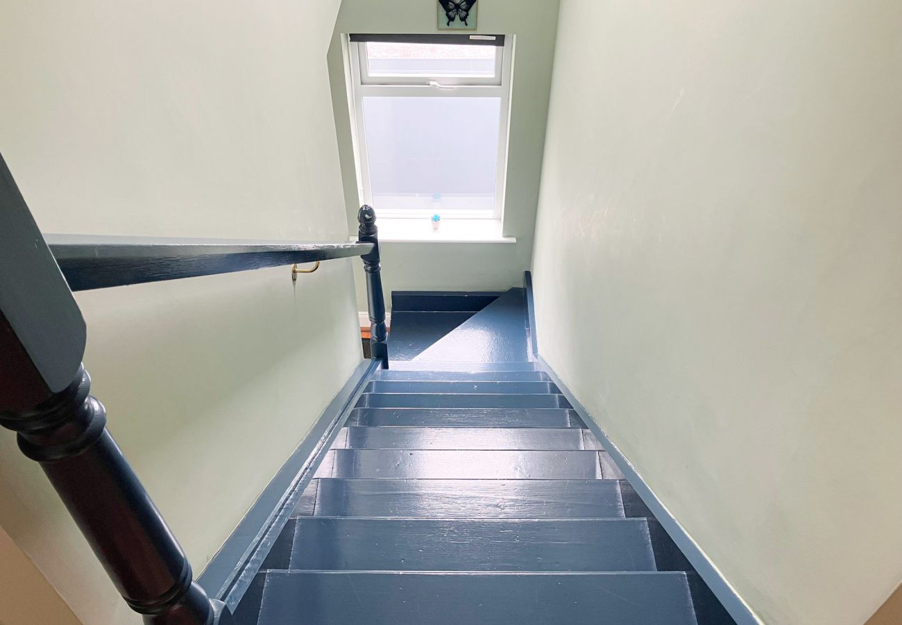 CarrauntoohilViewRetreatKillarneyKitchen. Wooden staircase to front door. 